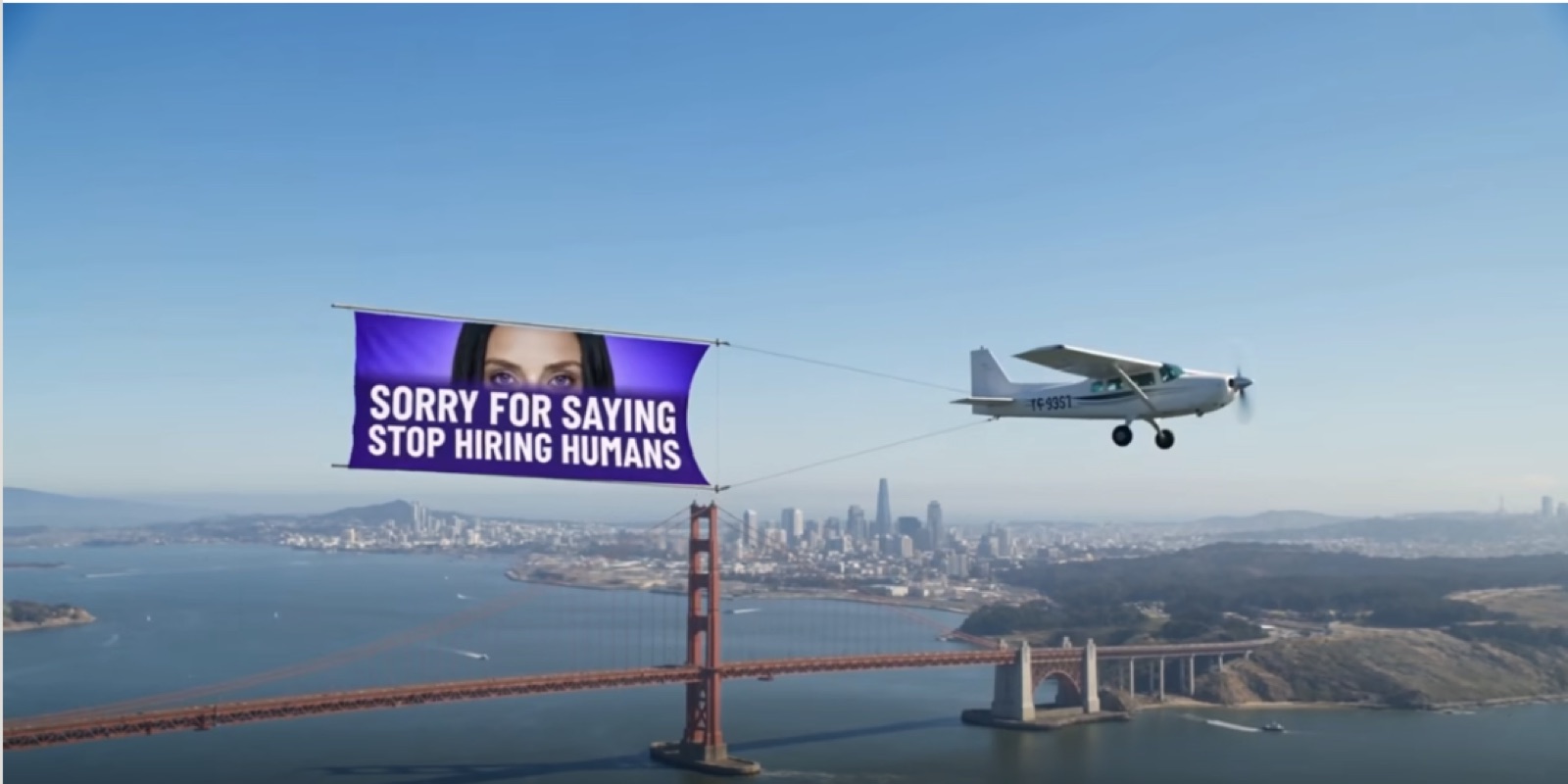 Plane flying a banner over San Francisco reading Sorry for saying stop hiring humans